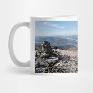 Hikers pass a navigation cairn as they descend back down Ben Nevis Mug